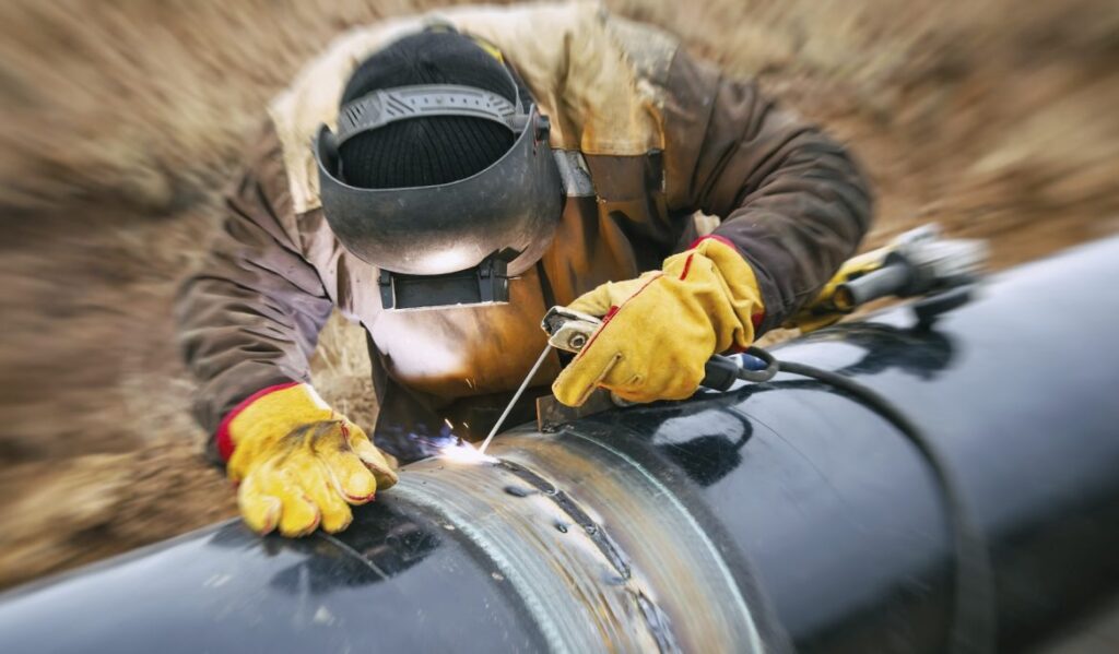 Oilfield Factoring, Oil and Gas Financing, Welder tacking Pipe